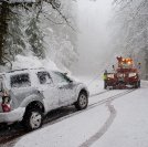 Car being towed after accident in snow storm